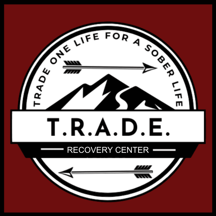 A red and white logo for the T.R.A.D.E. Recovery Center