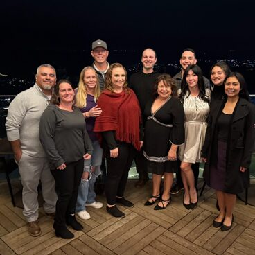 Friends posing on outdoor deck at night